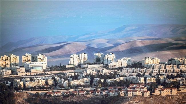 This picture, taken on November 17, 2018, from East Jerusalem al-Quds shows a view of the illegal Israeli settlement of Maale Adumim (C) with the Judaean desert seen in the background. (By AFP)