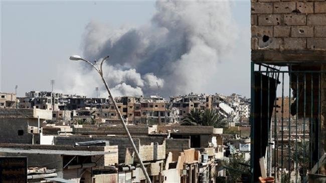 Smoke billowing out following a US-led coalition airstrike in the northern Syrian city of Raqqah on October 12, 2017 (Photo by Reuters)