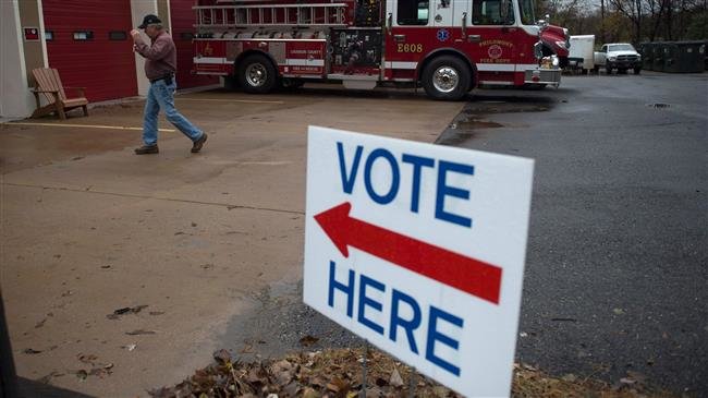A voter heads to a polling station during the midterm congressional elections at the Philomont Firehouse in Purcellville, Virginia on November 6, 2018. (Photo by AFP)