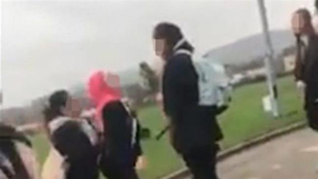 This blurred image taken from a video posted on the social media on November 27, 2018 purportedly shows a Syrian refugee girl being attacked in a school in Huddersfield, in northern England over wearing hijab.