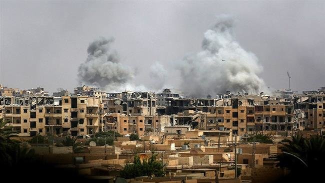 This file picture shows smoke billowing out following a coalition air strike in the western al-Daraiya neighborhood of the embattled northern Syrian city of Raqqah. (Photo by AFP)
