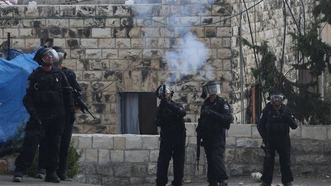 The file picture shows Israeli soldiers fire their weapons and use tear gas on Palestinians in Jerusalem al-Quds.