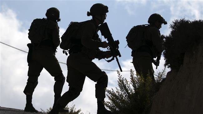 Israeli forces take position following clashes between Israeli settlers and Palestinian from the nearby Urif village, south of Nablus, in Tel Aviv occupied West Bank on October 10, 2018. (Photo by AFP)