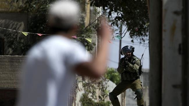 An Israeli soldier aims at a Palestinian protester following a weekly demonstration against the expropriation of Palestinian land by Israel in the village of Kafr Qaddum, near Nablus in the occupied West Bank, on September 7, 2018. (Photo by AFP)