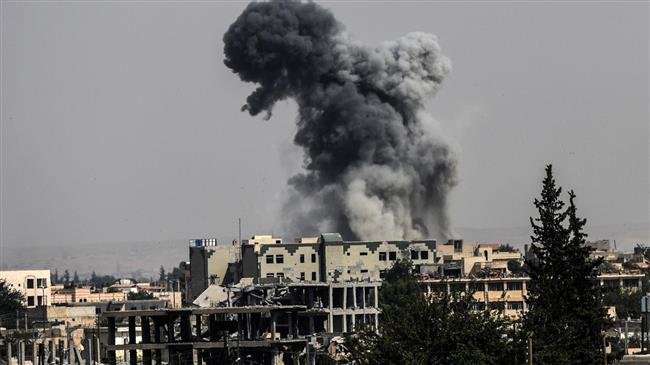 In this file picture, heavy smoke billows following an airstrike in Raqqa during an offensive by the US-backed Syrian Democratic Forces to retake the city from Daesh Takfiri terrorist group. (Photo by AFP)