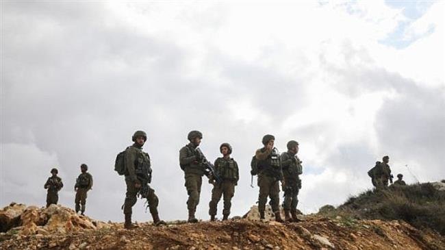 Israeli troops guard the scene of a shooting attack near Givat Assaf, in the occupied central West Bank, on December 13, 2018.