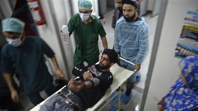 Medical personnel at the main hospital in Srinagar, Kashmir, cart away a youth wounded by pellet-shot during clashes with Indian troops on December 15, 2018. (AFP)